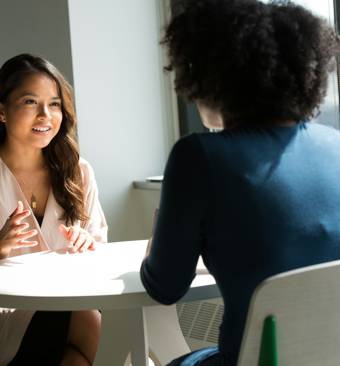 Two women talking during an interview for a study under independent IRB review