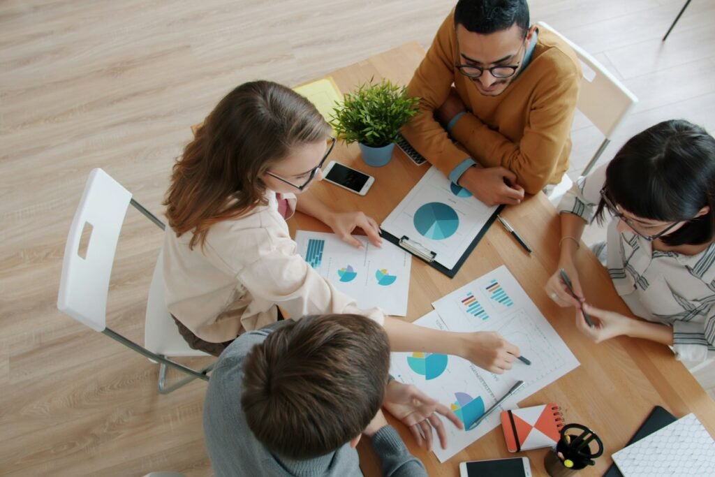 Research team reviewing charts around a table
